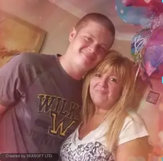 A young man and woman smiling, standing close together, with balloons in the background, celebrating a special occasion.