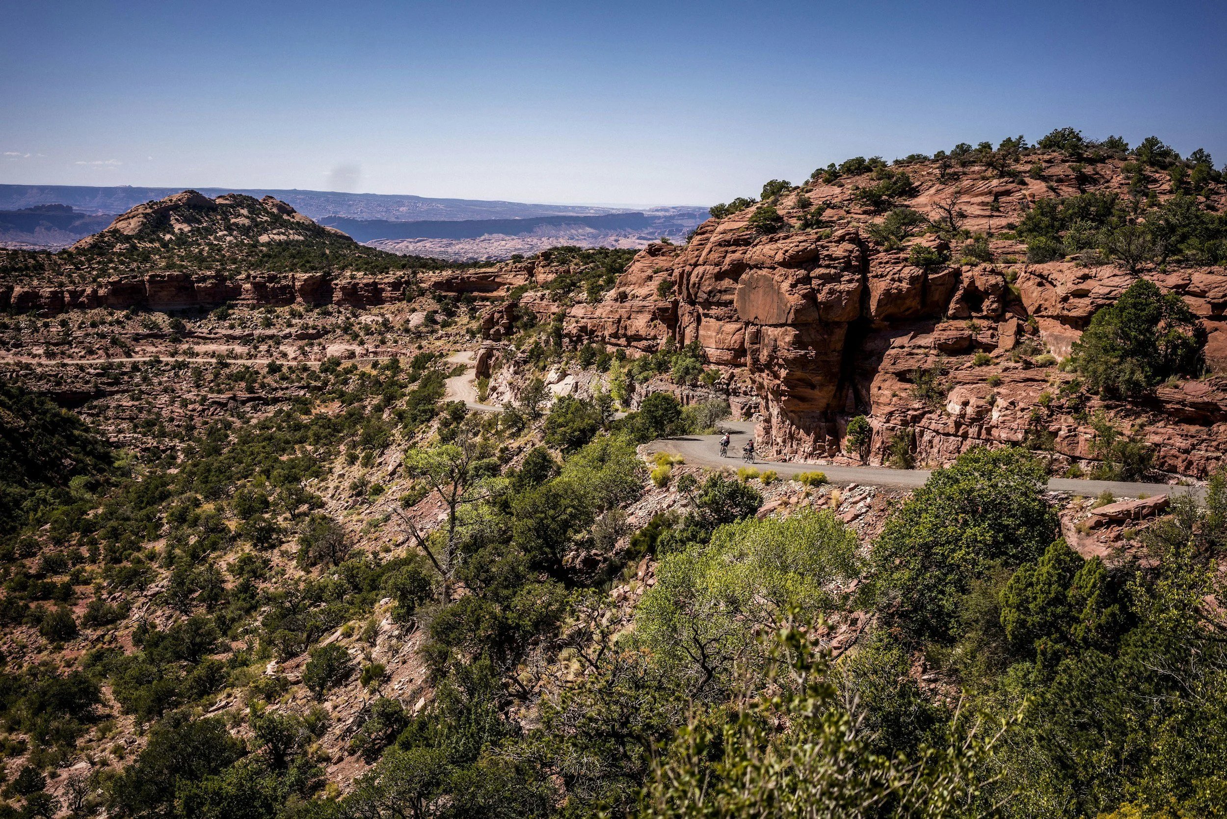 bike riders in Utah riding along rock formations