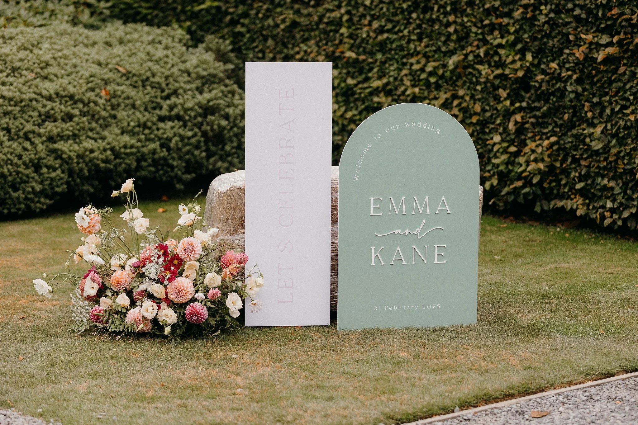 Autumnal pink and orange wedding welcome sign flowers