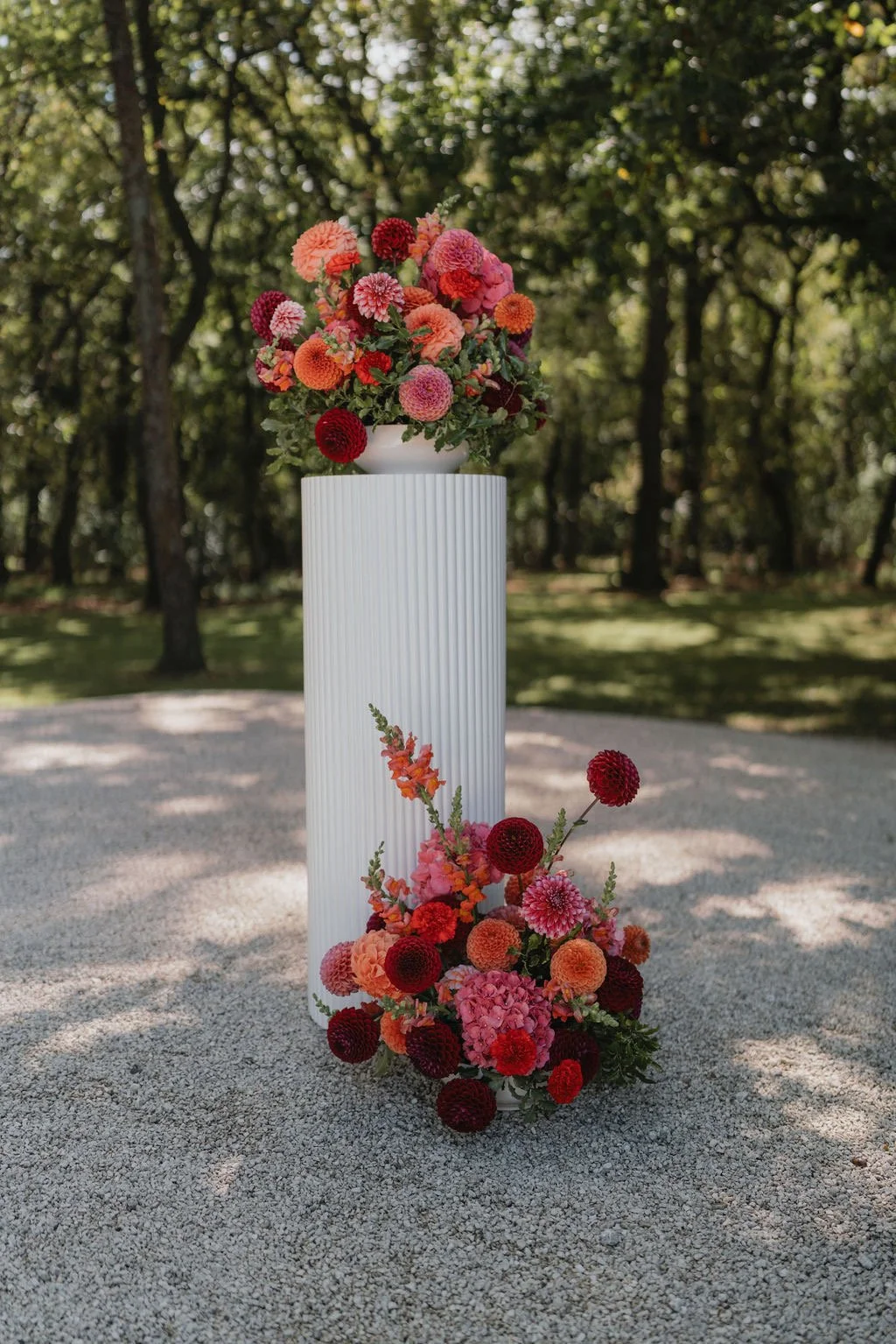 Pink orange and red wedding floral plinths