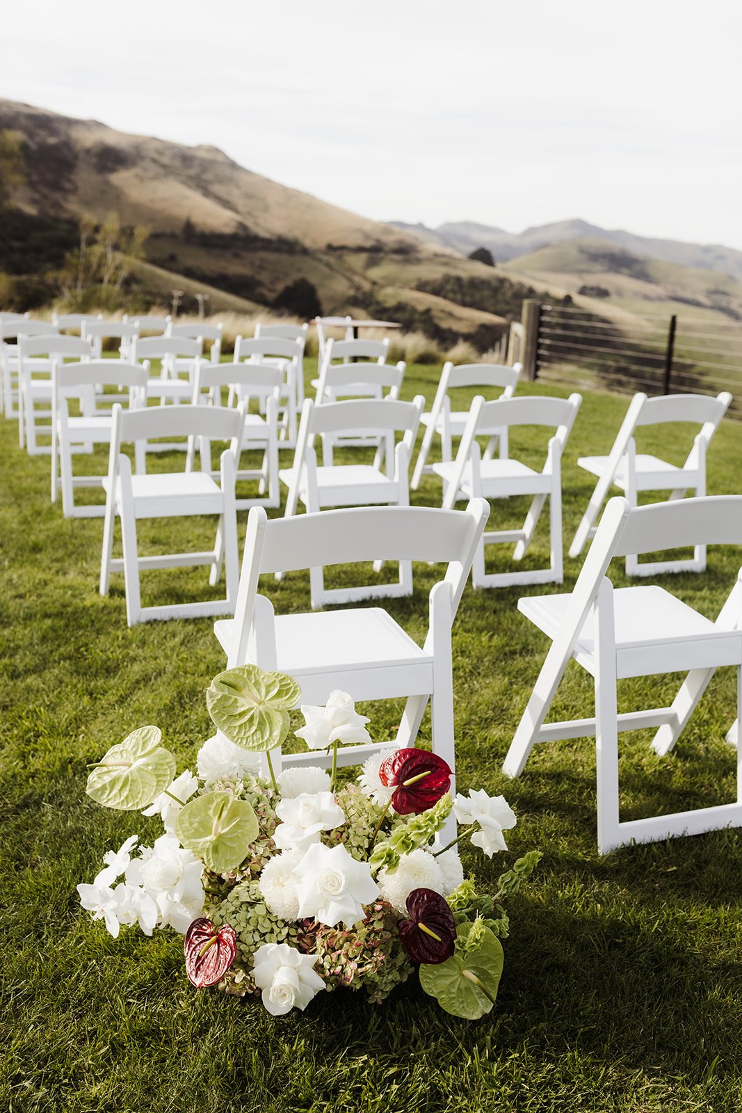 Red white and green aisle flowers