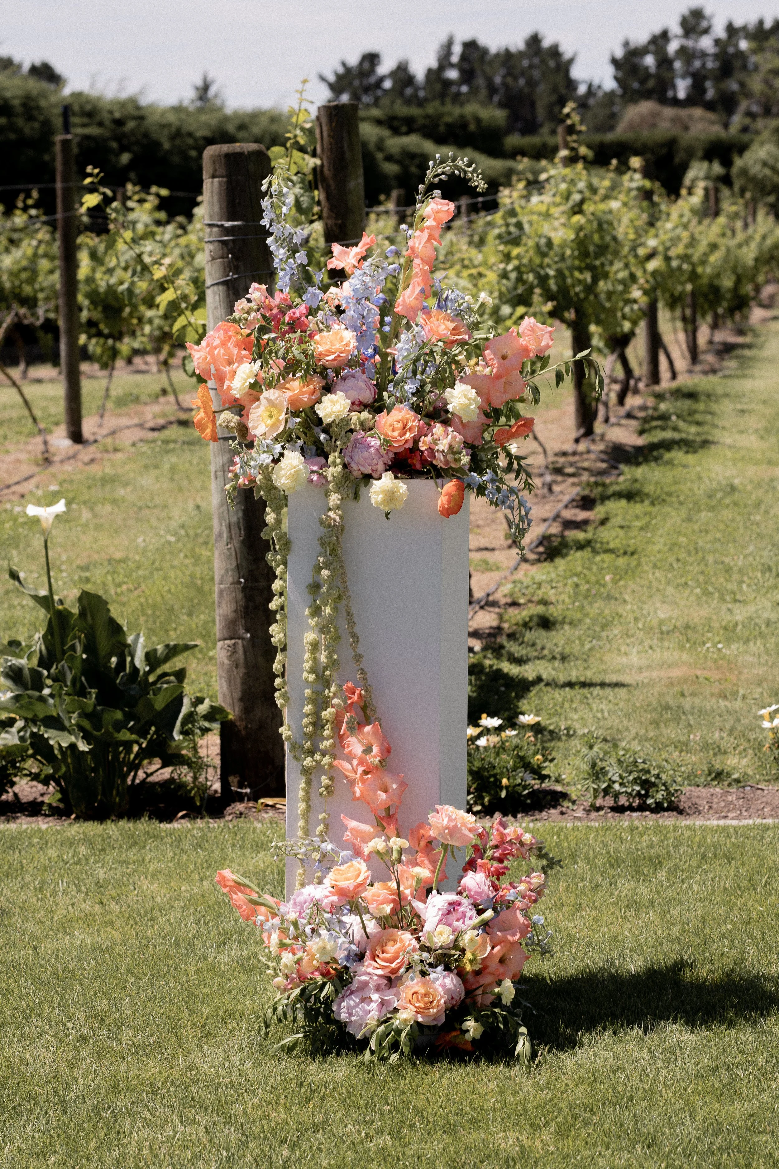 bright and colourful wedding floral plinths