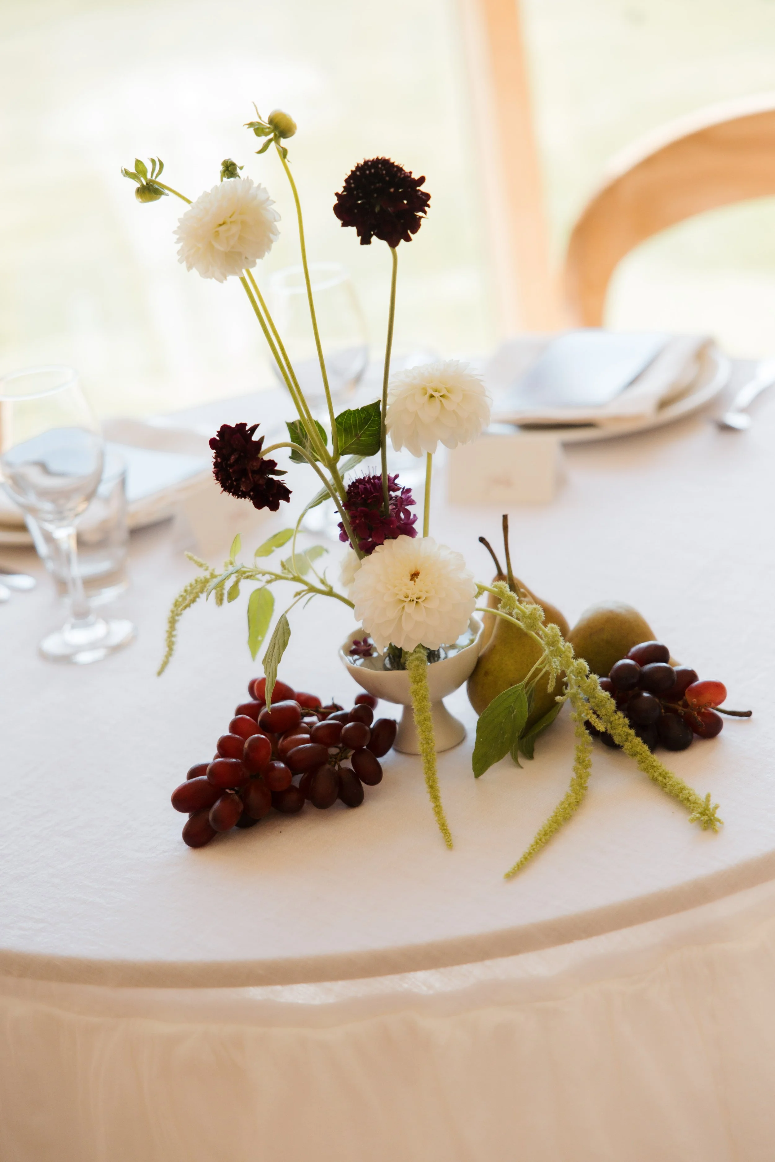 Red and white wedding table flowers with fruit