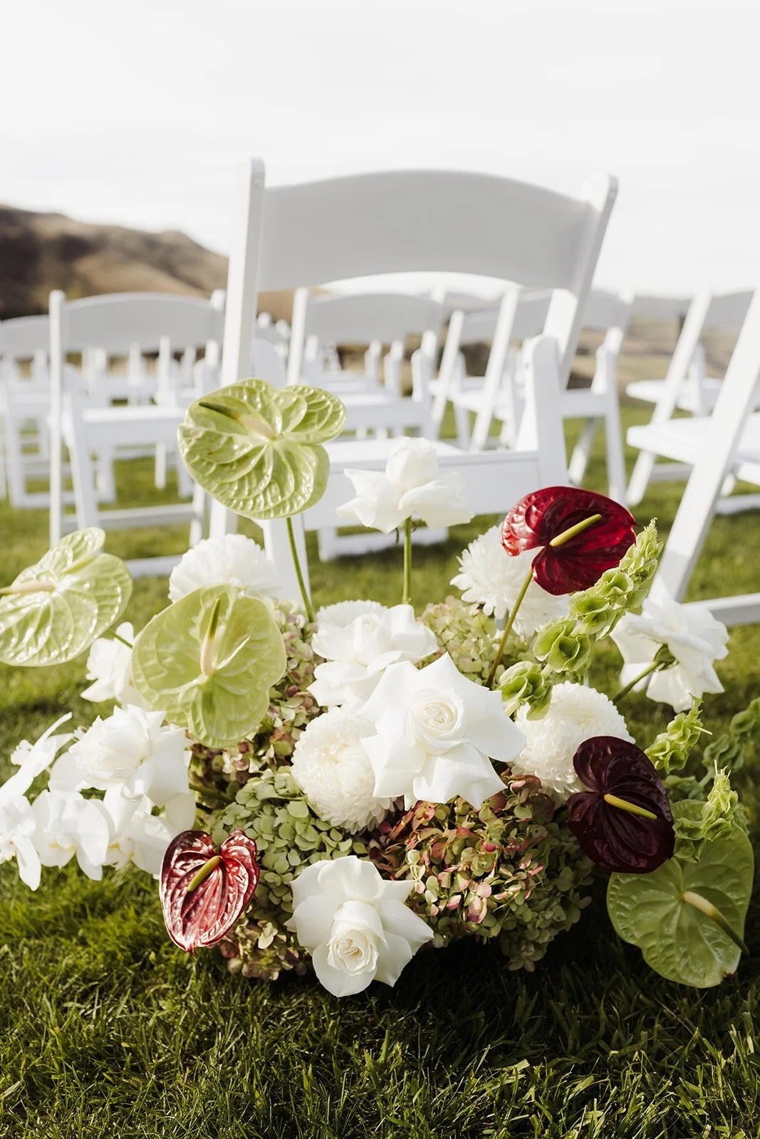red white and green aisle flowers