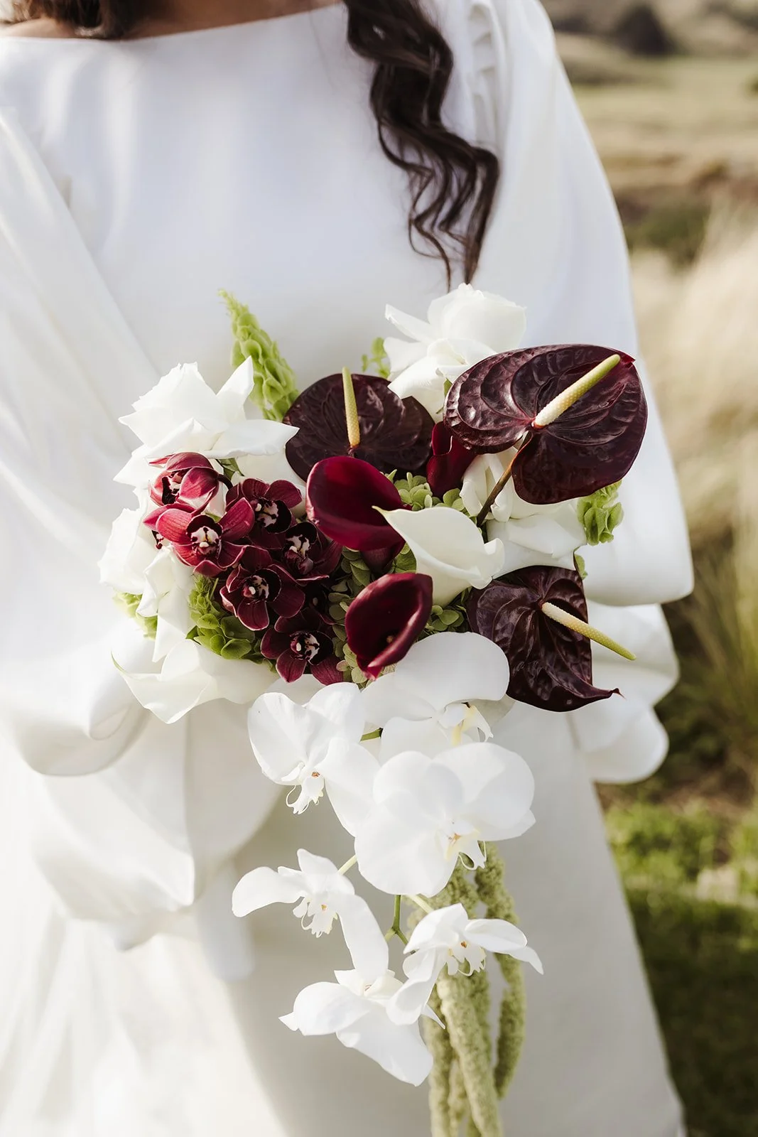 Dark red white and green bouquet with orchid