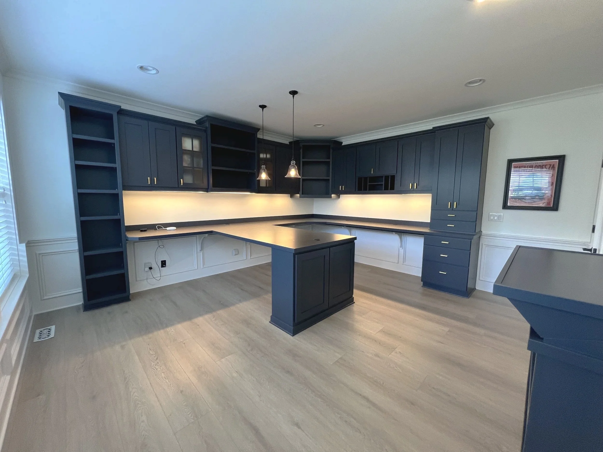 Empty office with dark blue cabinets.