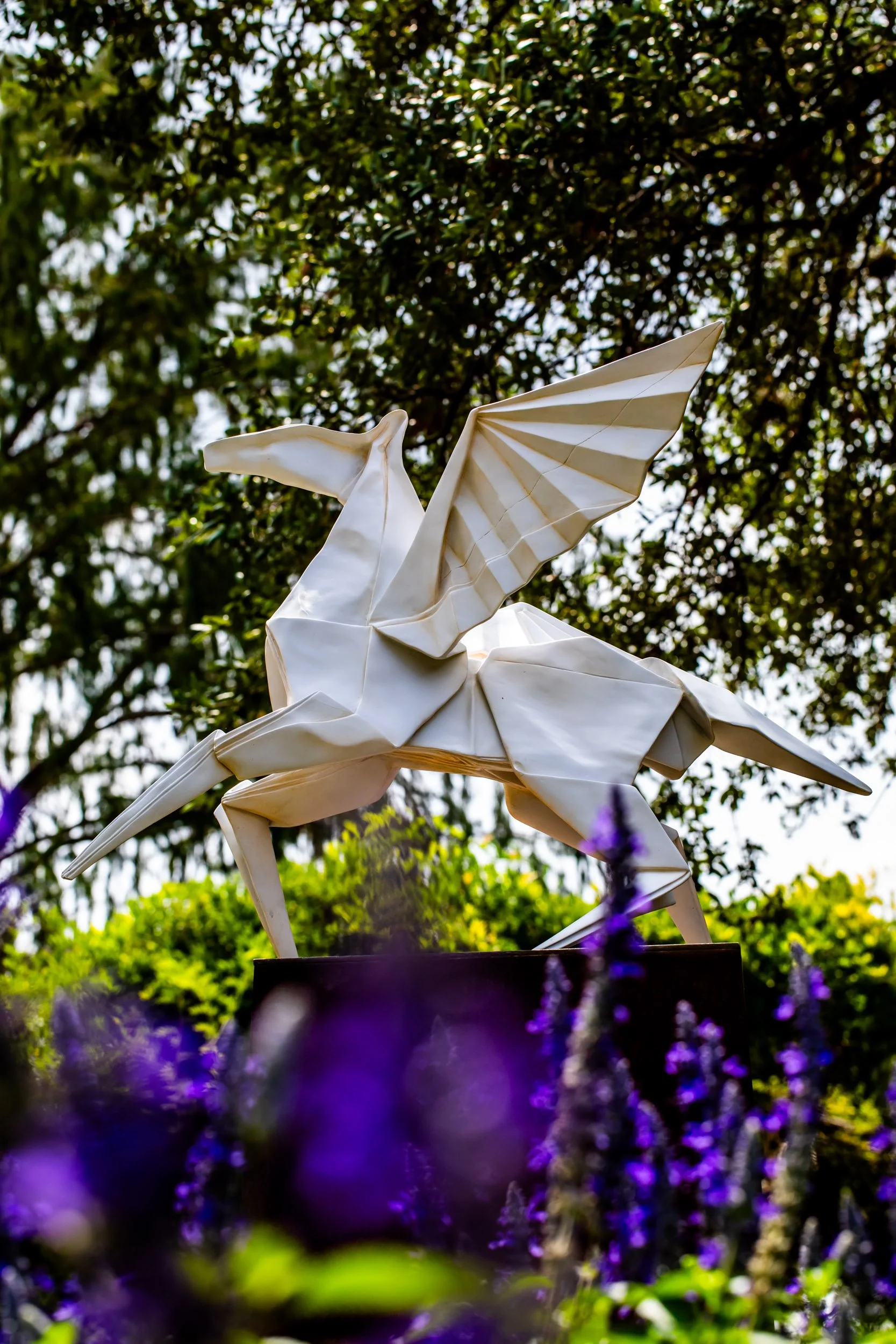 origami-pegasus-sculpture-outdoor-garden-art-purple-flowers.jpg
