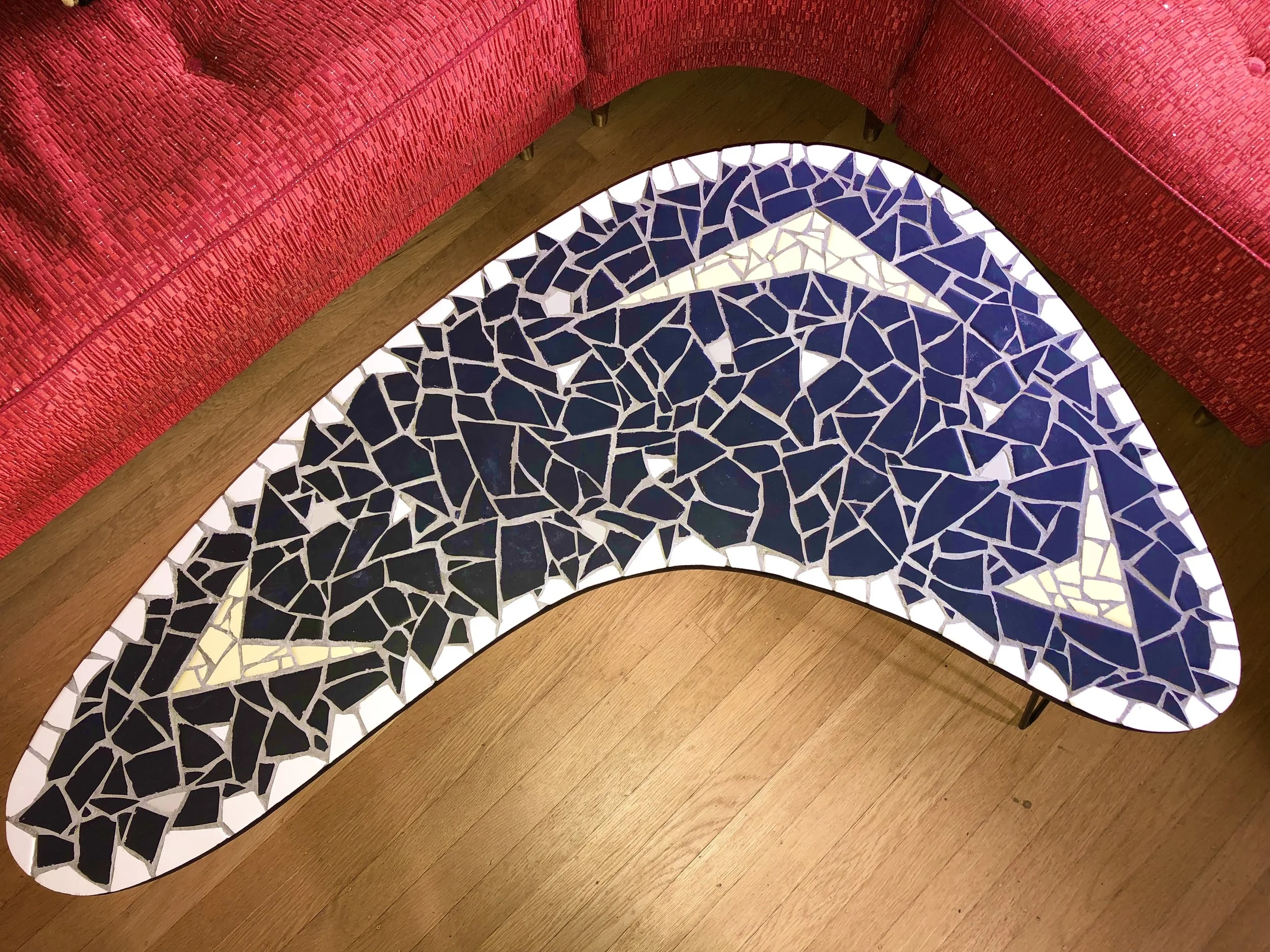 Boomerang table. Ceramic tiles on wood