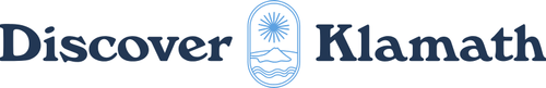 Logo of Discover Klamath with stylized emblem of a sun rising over water.