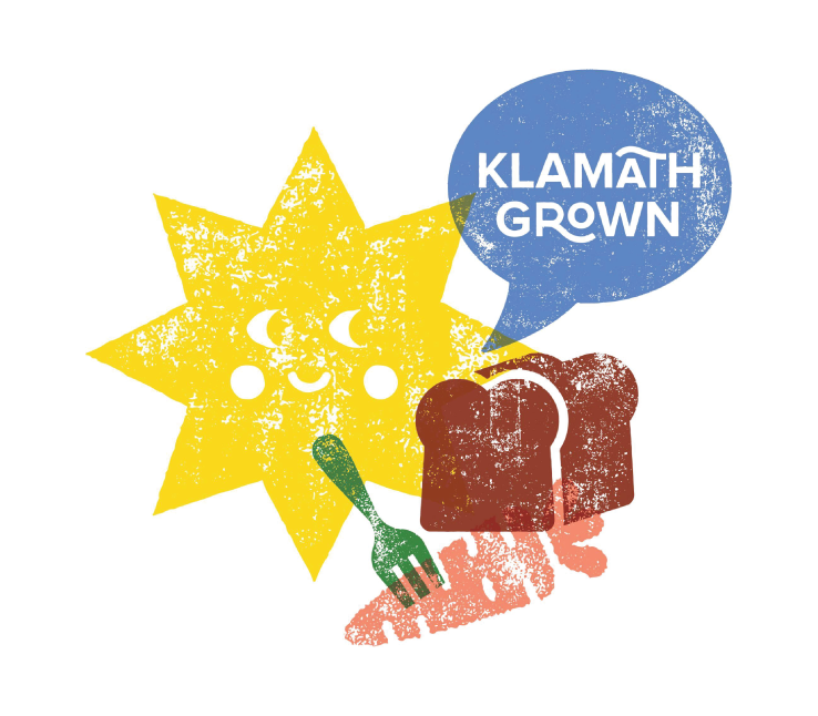 A cartoon sun with a smiling face, a speech bubble saying "Klamath Grown," slices of bread, a green fork, and a red background resembling a map or terrain.