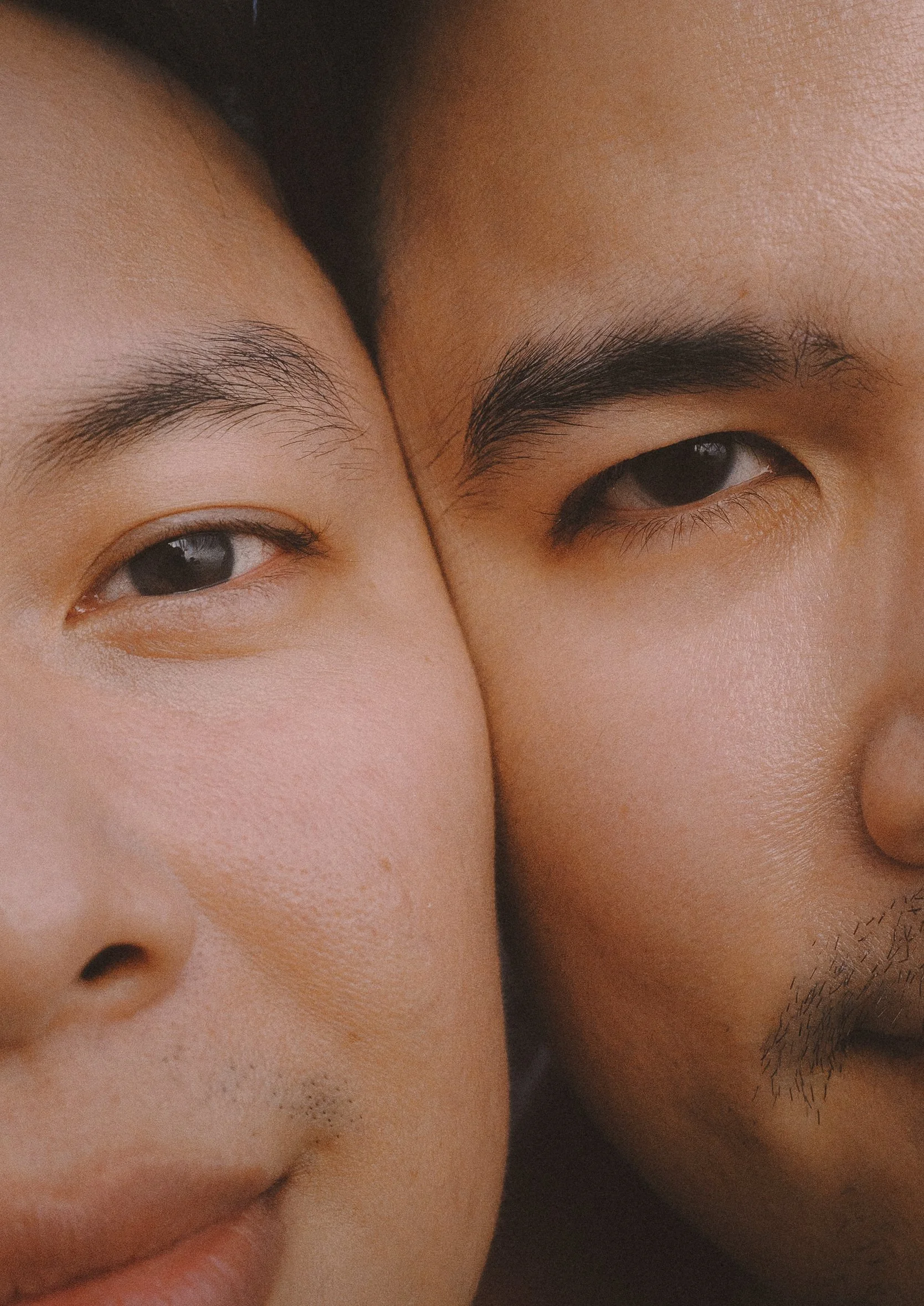 Close-up of two faces with their foreheads and eyes touching.