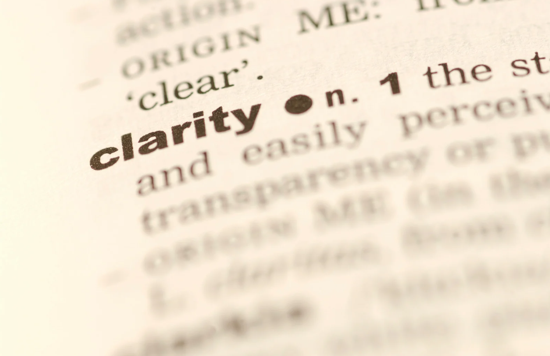 Close-up of a dictionary page with the word 'clarity' in bold.