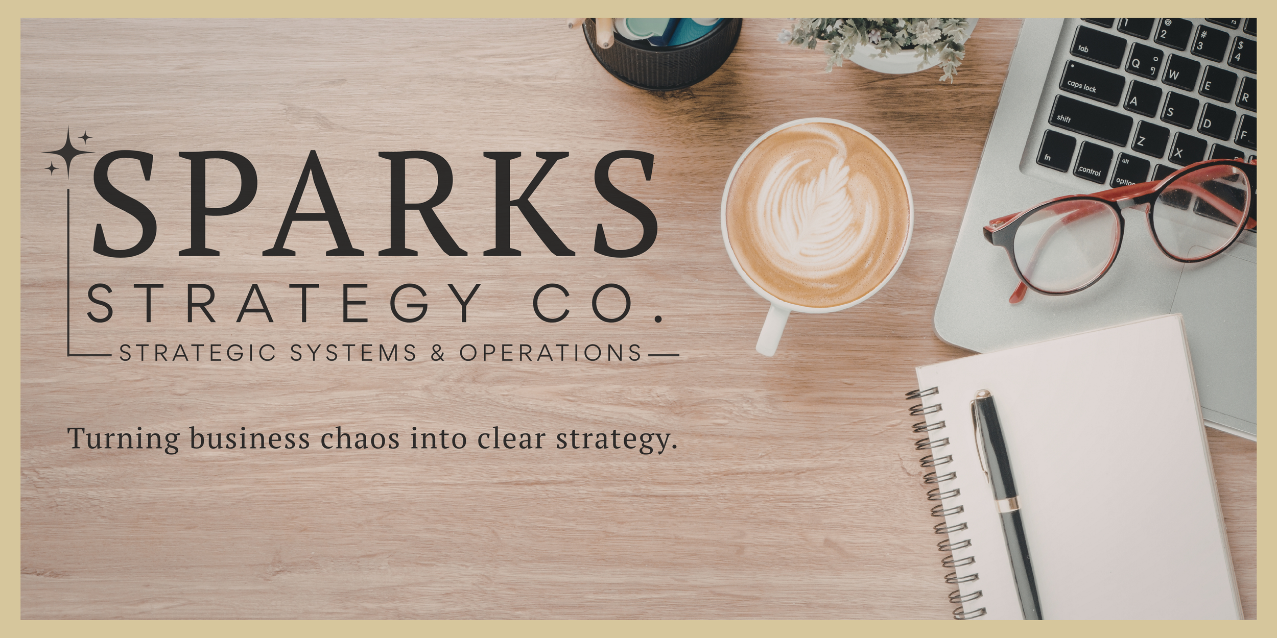 Workspace with a wooden desk, a coffee cup with latte art, eyeglasses, a laptop, a notebook with a pen, a potted plant, and a container holding pens.