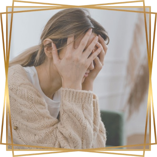 Dialectical Behavior Therapy Icon of Woman Holding Head in Hands wearing a Cream Sweater Sitting on Green Chair in Gold Frame