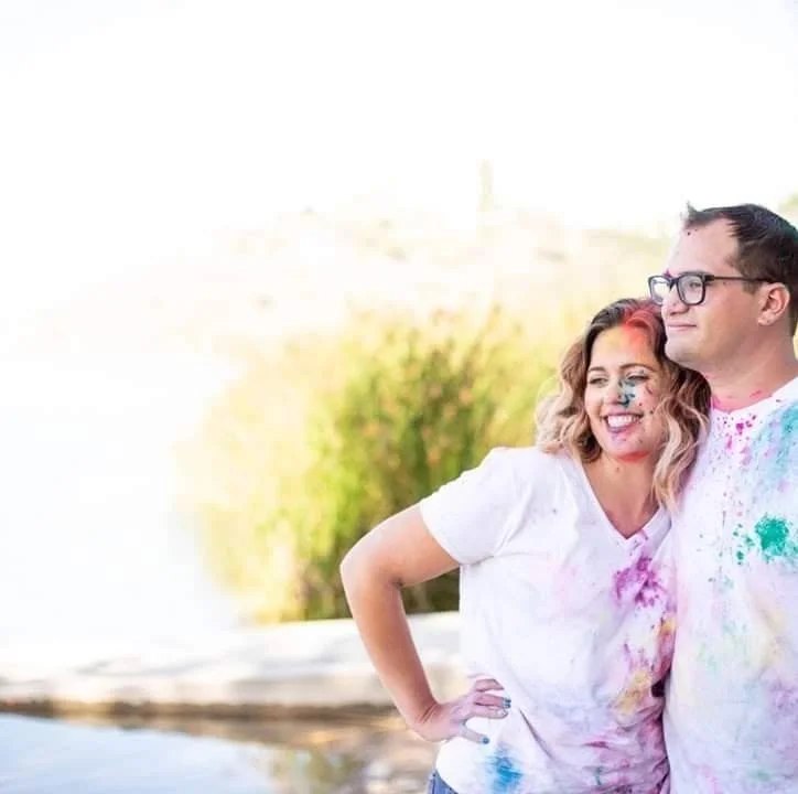 Matti Mattilyn Millman and Husband Standing Together Covered in Colored Powder