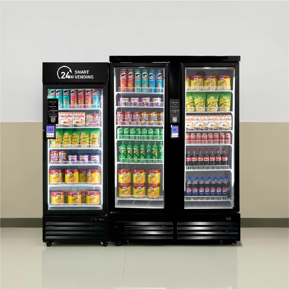 A set of three vending machines filled with snacks and beverages, located against a beige wall. The vending machines include selections of chips, cookies, soda, and bottled drinks.