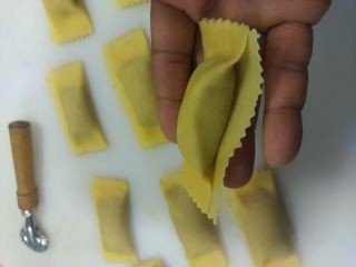 Freshly made Agnolotti, sitting in the Chef's hand.