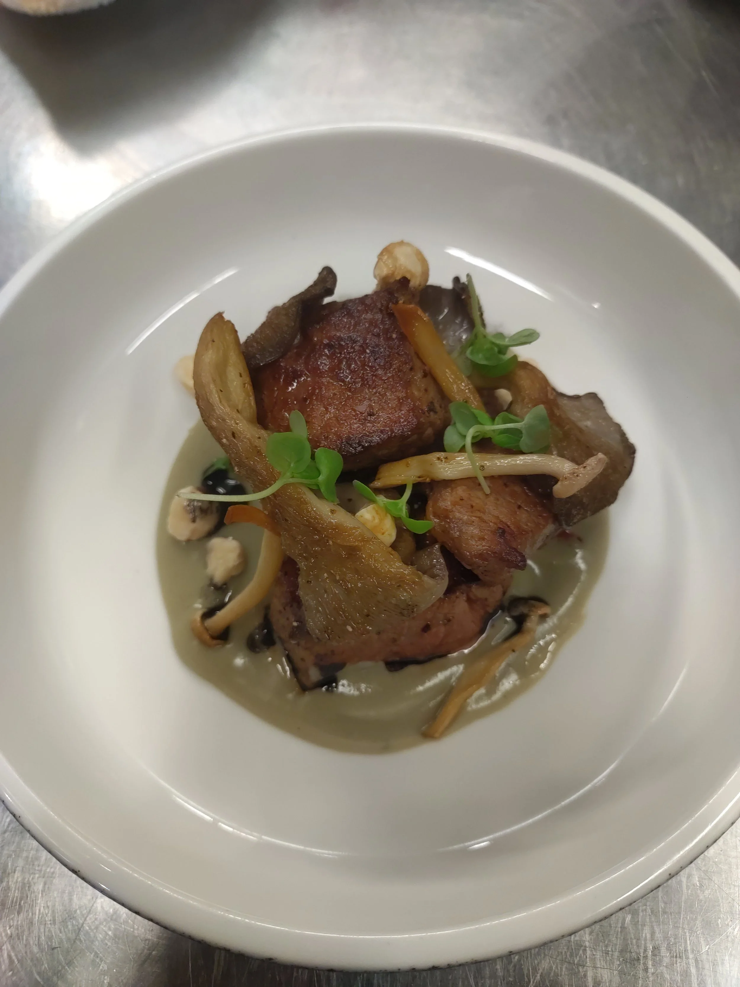 Seared Beef & King Oyster Mushrooms, served with Gorgonzola-Pecorino Fondue. Garnished with microgreens and toasted Hazelnuts.