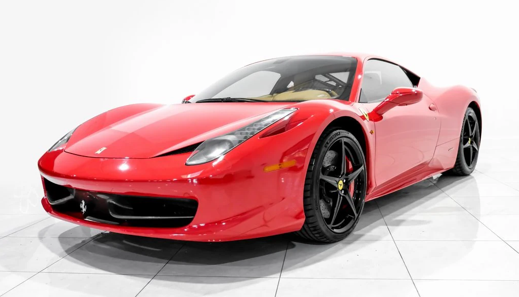 Red Ferrari sports car on white background in a studio setting.