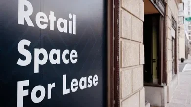 Retail space for lease sign on a building exterior.