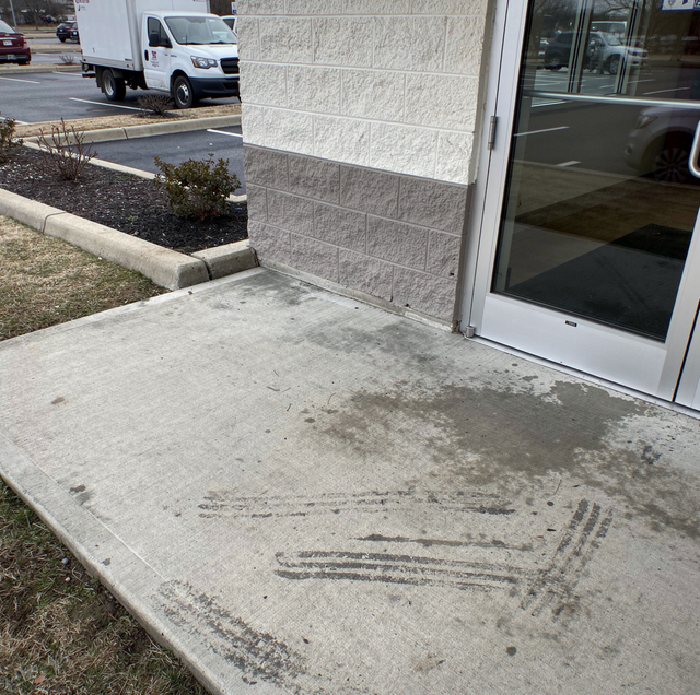 dirty commercial storefront awaiting scheduled pressure washing