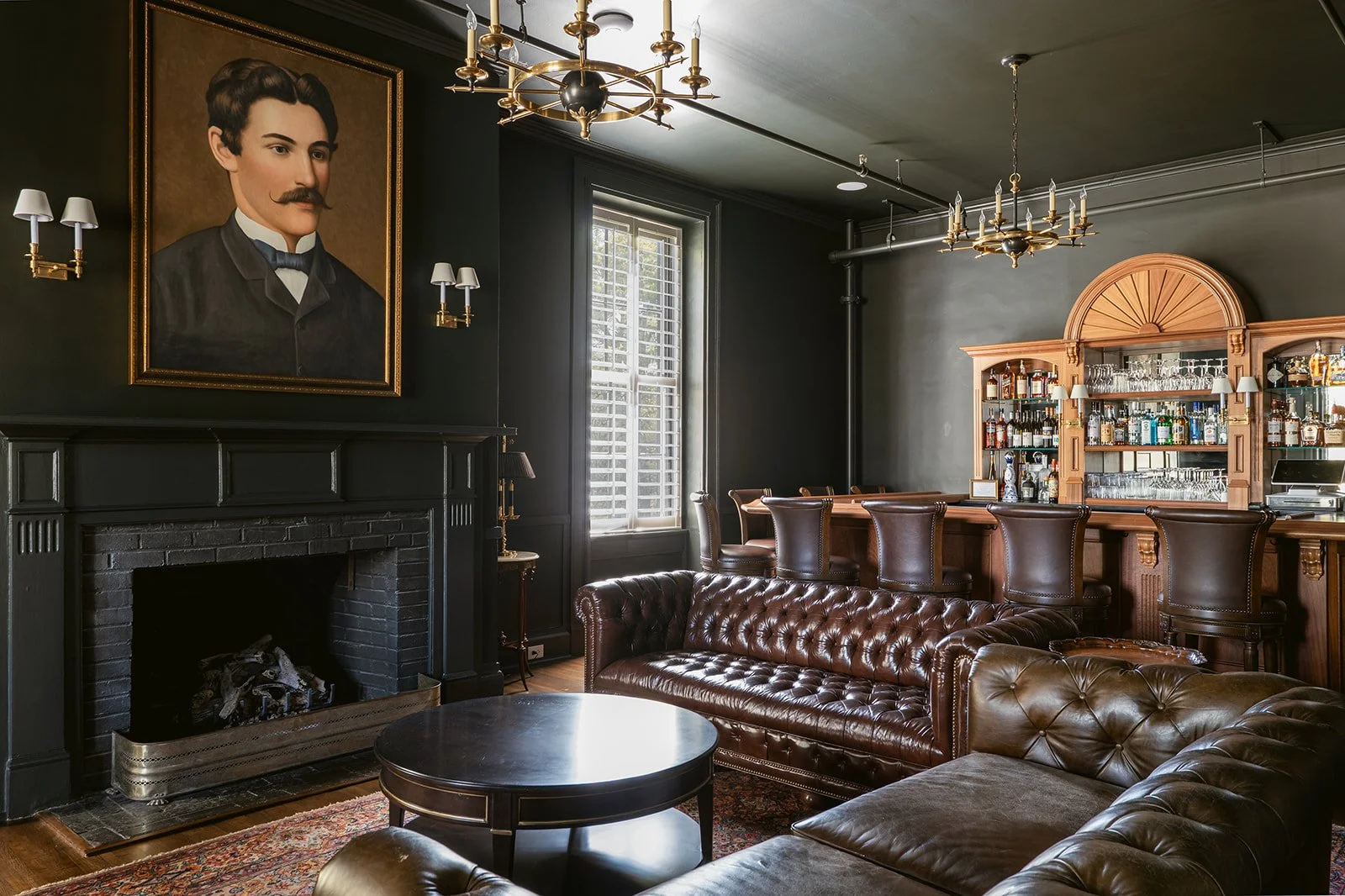 Carlisle's Restaurant Lounge in Hotel Everett | Boutique Hotel in Winnsboro, SC, historic hotel | Interior of a vintage-style bar or lounge with dark walls.