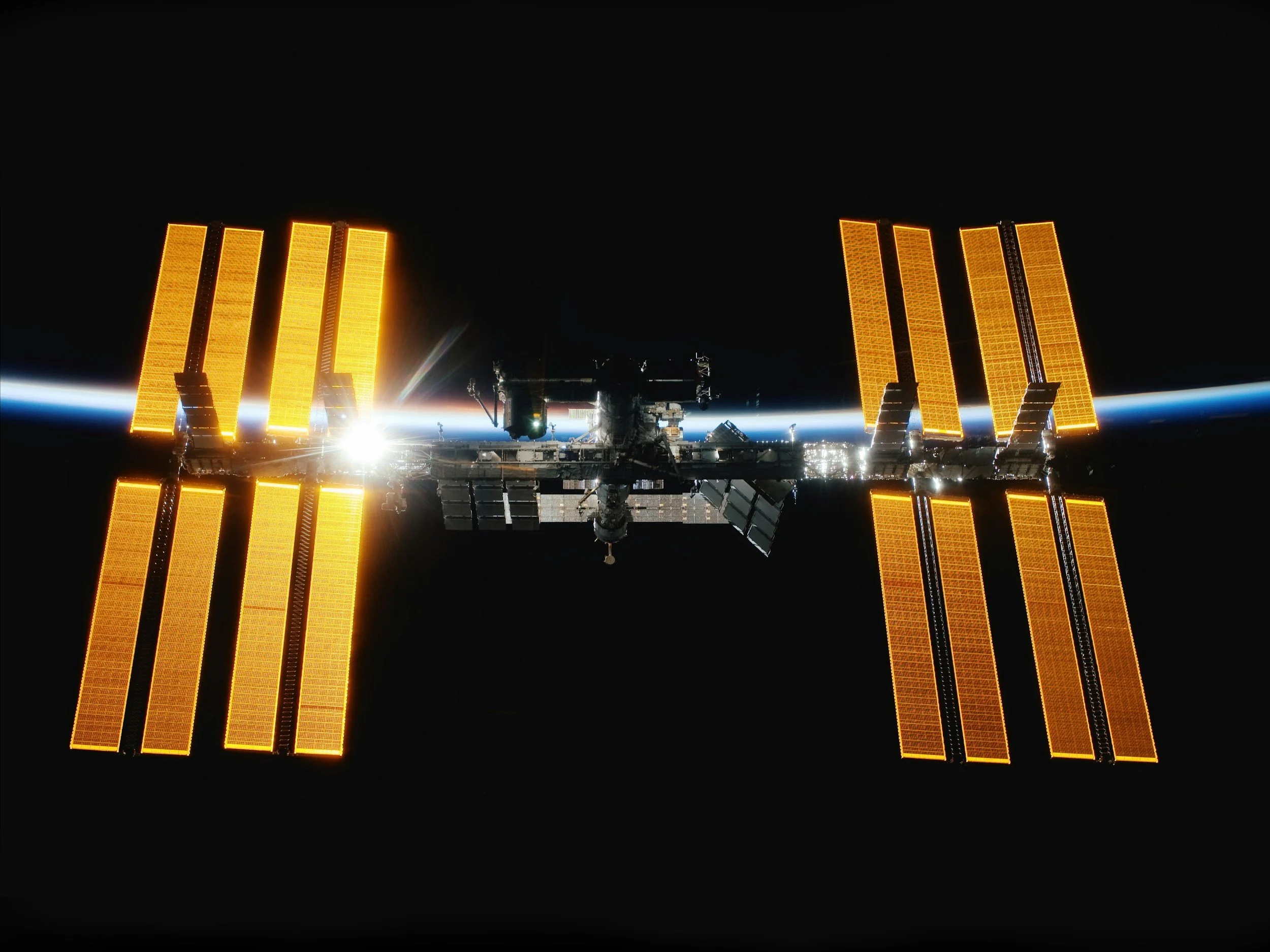 The image shows the International Space Station orbiting Earth at night, illuminated by sunlight. Mission Assurance is not new, but has evolved over the years, and is in a period of great change right now.