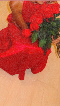 A person dressed in red holding a bouquet of red roses with green leaves.