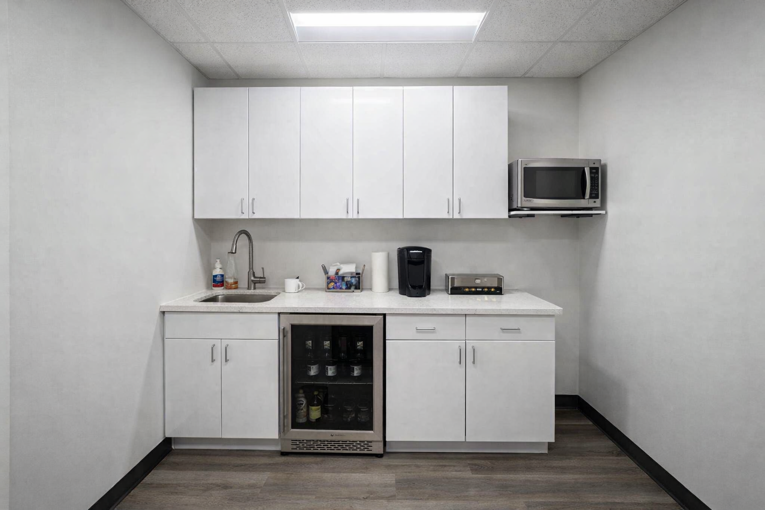kitchenette installation with cabinet assembly, countertop installation, vinyl plank flooring, drywall finishing, painting and ceiling lighting fixtures