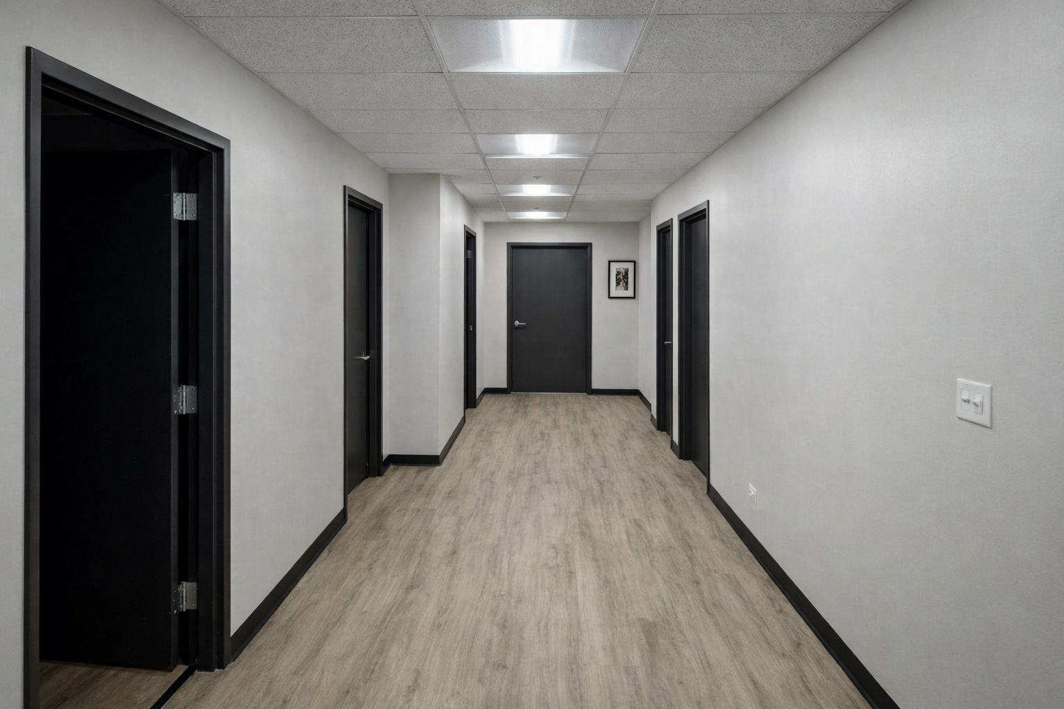 commercial hallway renovation with carpet tile flooring, suspended ceiling installation, ceiling lighting fixtures, drywall finishing and interior doors
