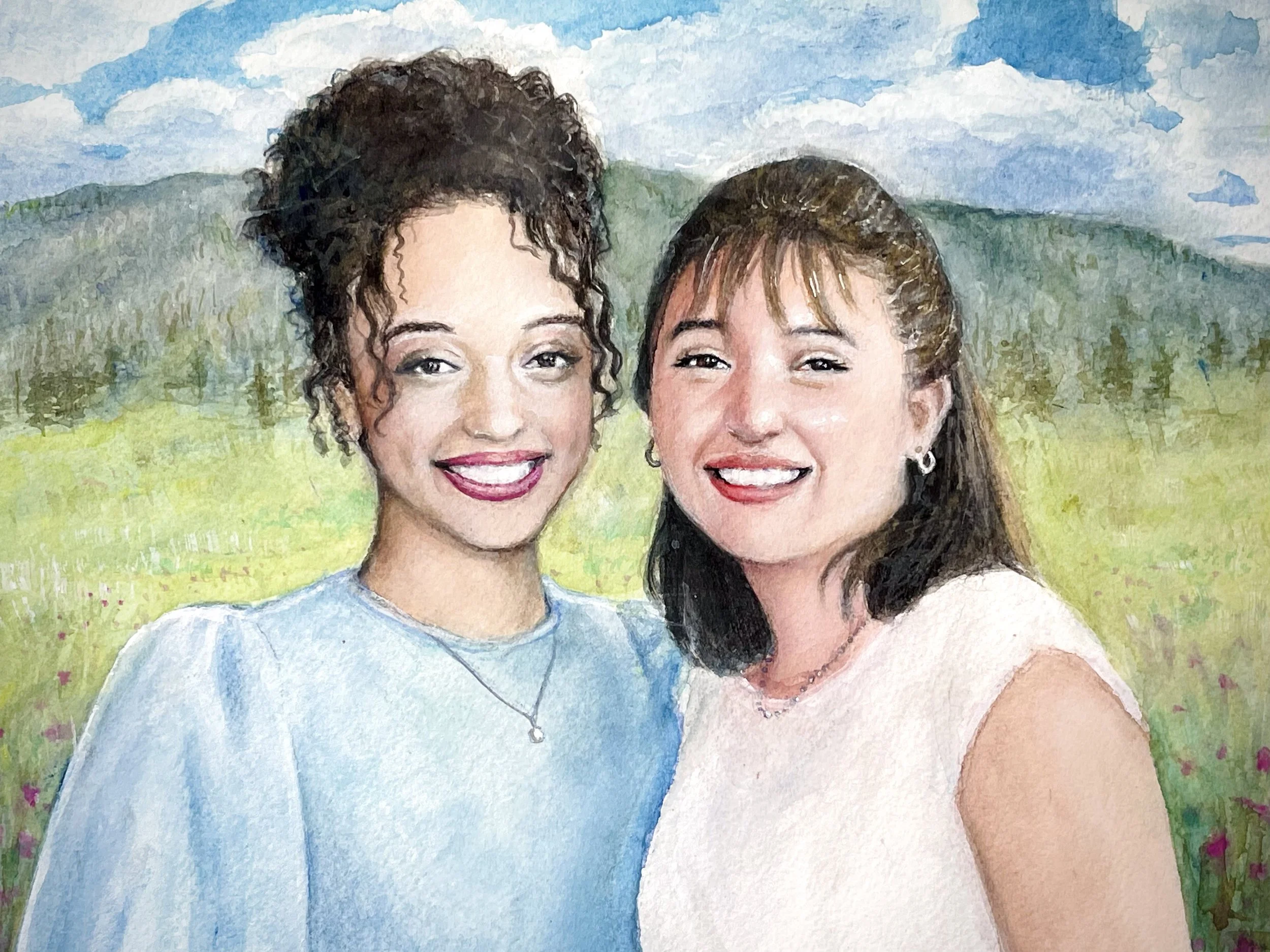 Watercolor painting of two women smiling outdoors with a grassy landscape and hills in the background.
