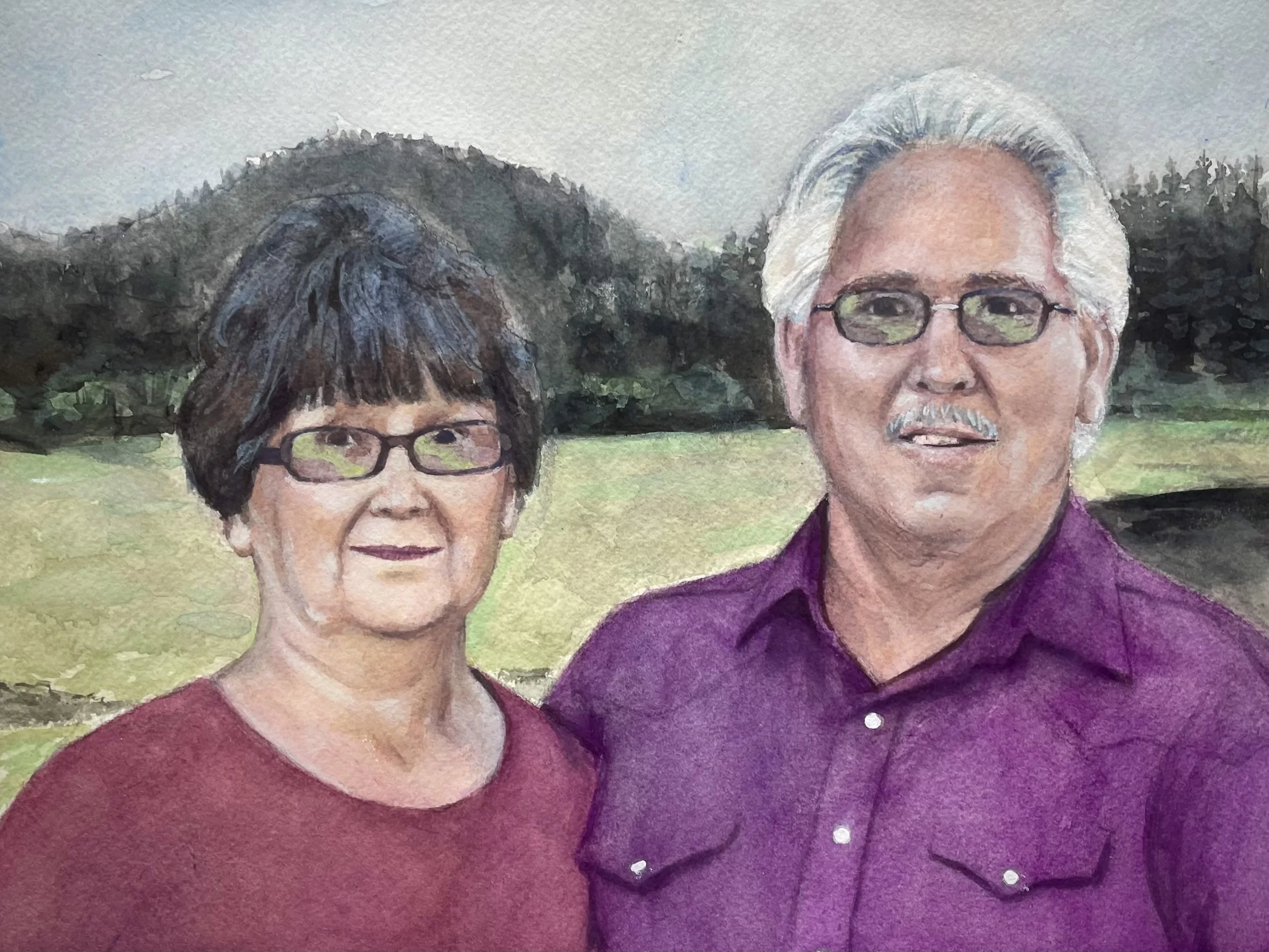 A watercolor-style painting of an older woman and man standing outdoors with trees and a grassy field in the background. The woman has short dark hair and wears glasses and a maroon top. The man has gray hair, a mustache, glasses, and wears a purple shirt.