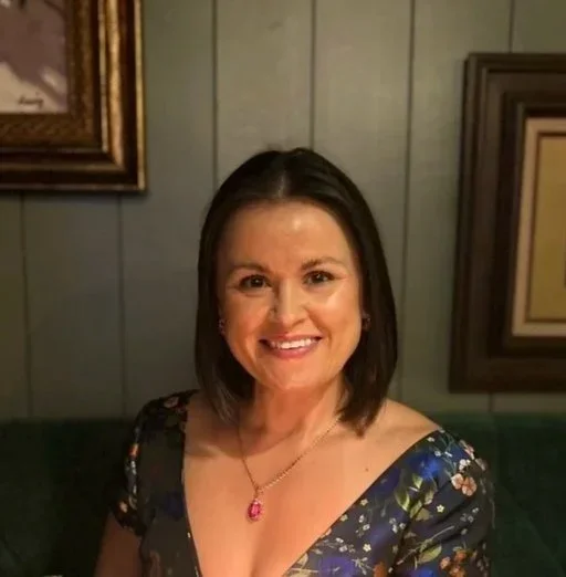 Tatyana Kirsanova, animal communicator and founder of Veil Whispers, smiling in a floral dress