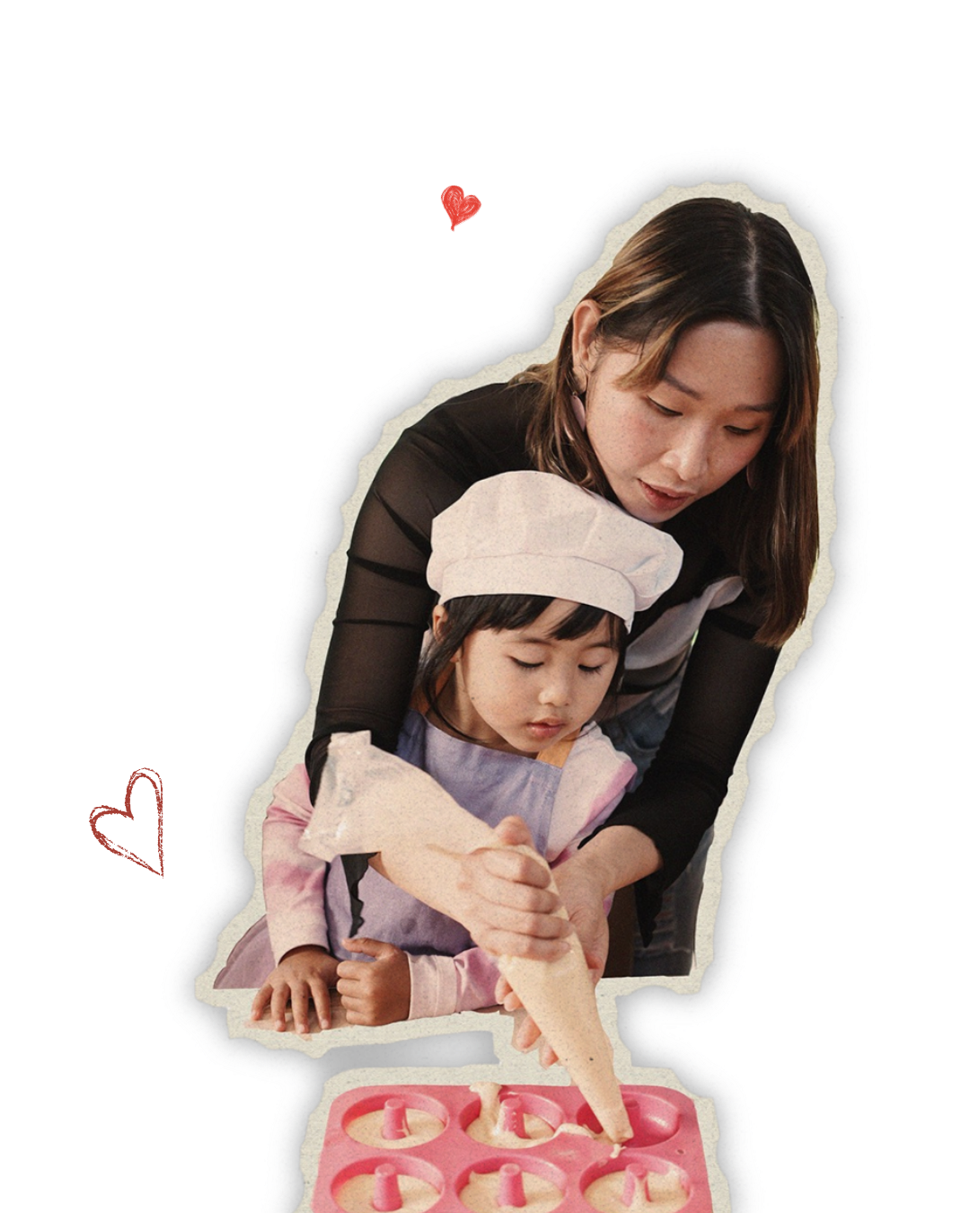 A woman assisting a young girl in baking, the girl filling cupcake molds with batter from a piping bag, both focused on the task.