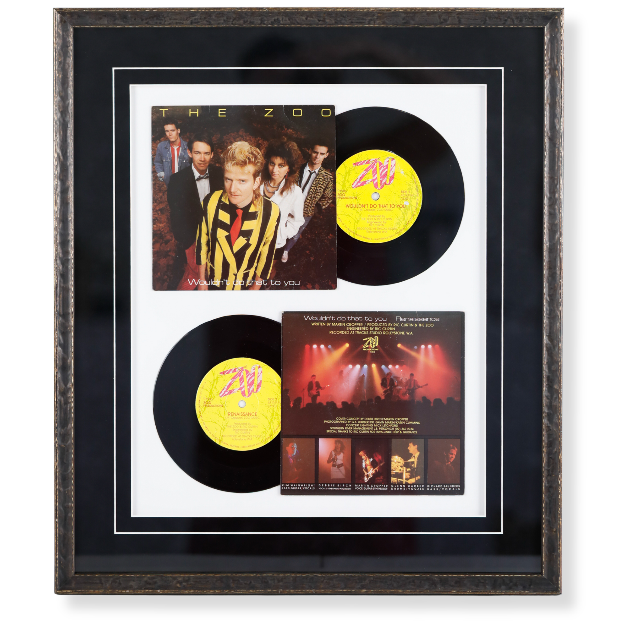 Custom framed music memorabilia display featuring vinyl records, album artwork, and band photography.