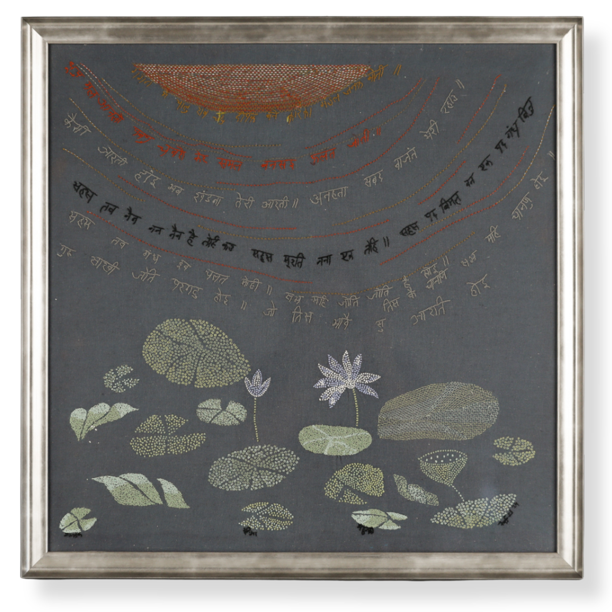 Custom framed botanical embroidery artwork featuring floral stitching on dark fabric with a silver metallic frame. 