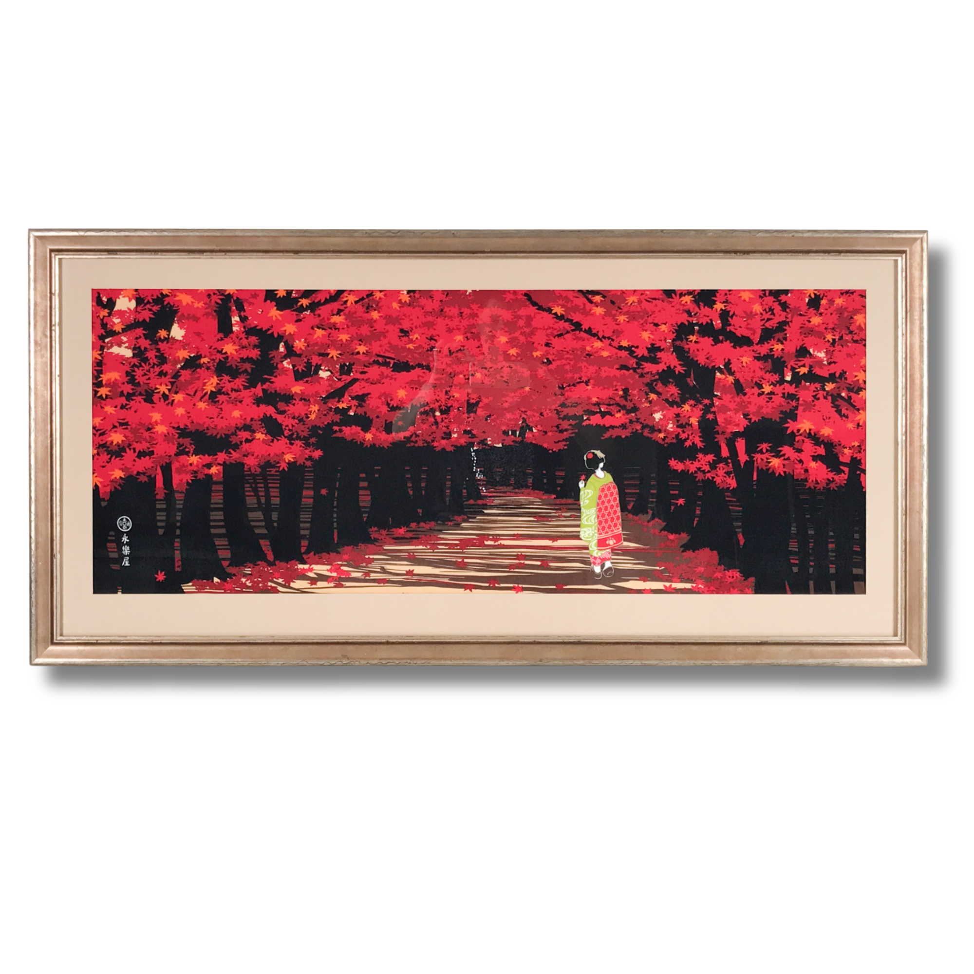 Framed Japanese-style artwork depicting a woman in traditional kimono walking along a path surrounded by vibrant red autumn leaves.