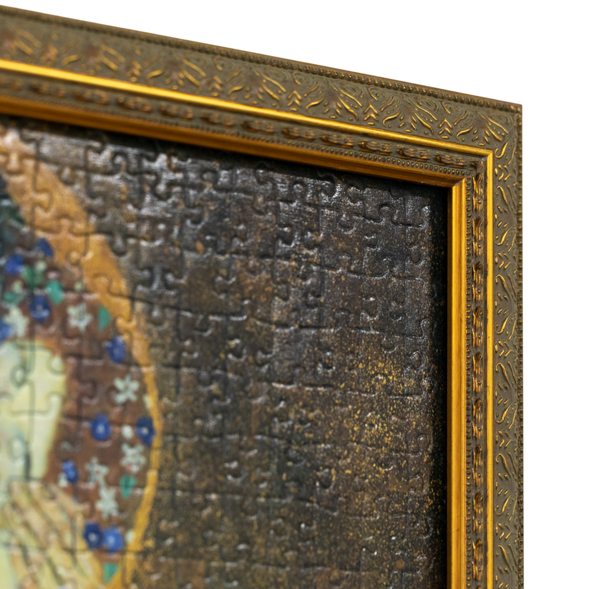 Close-up of ornate custom framed Gustav Klimt "The Kiss" jigsaw puzzle featuring decorative gold moulding details.