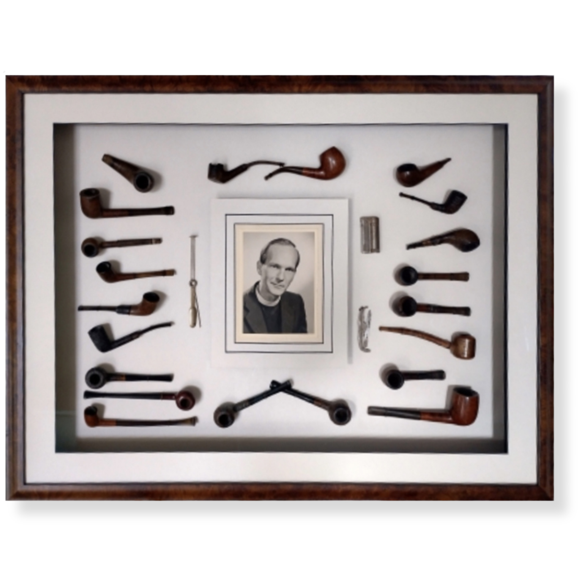 Custom framed family heirloom display featuring a collection of vintage pipes, portrait photograph, and keepsake objects.