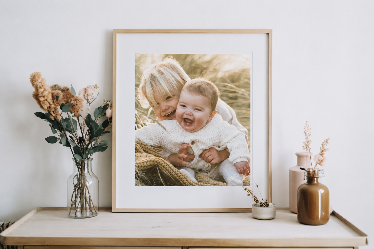 Framed family portrait print displayed in a styled home interior, showcasing professional photo printing by Framed.