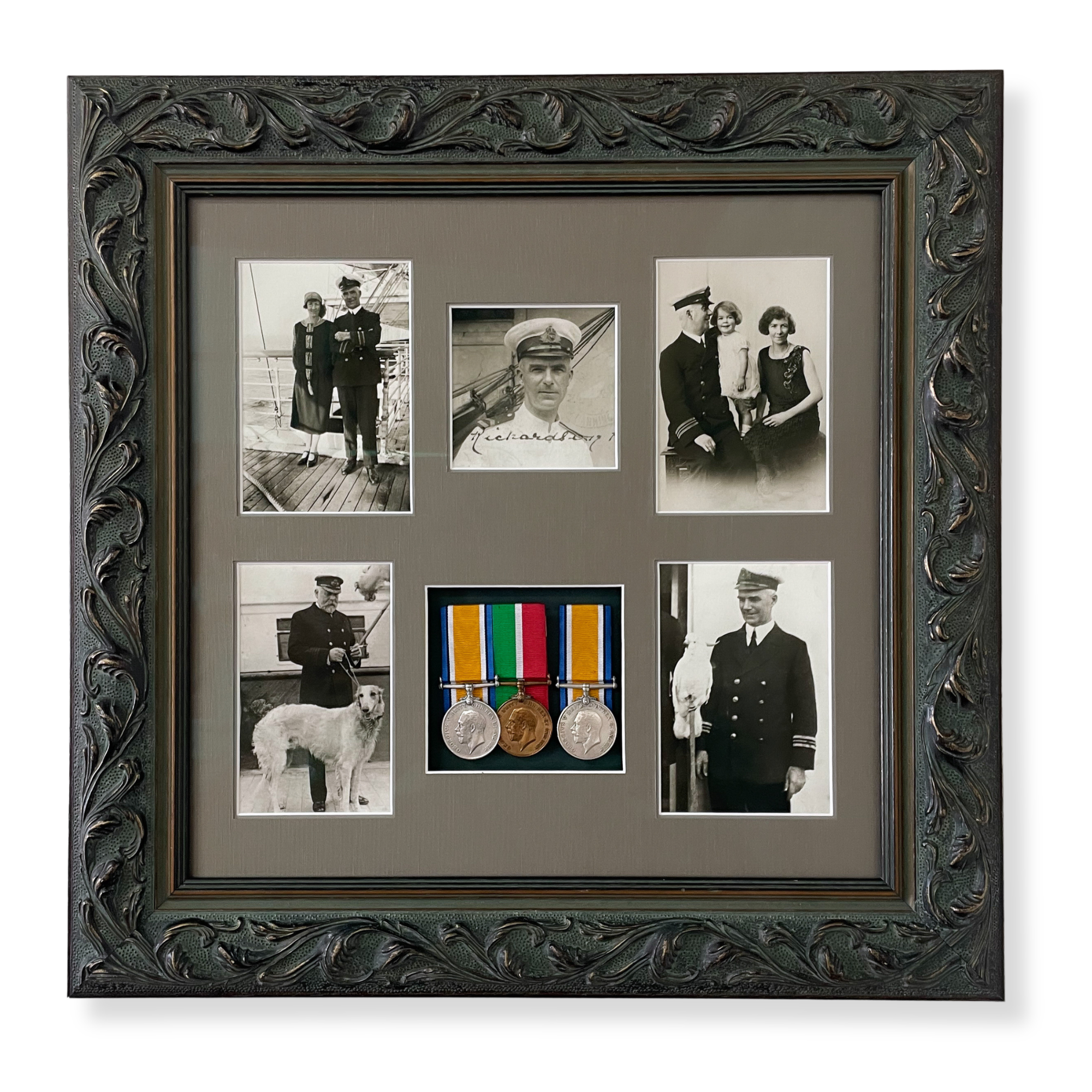 Custom framed naval service memorabilia display featuring military medals, vintage family photographs, and a historic photograph with the captain of the Titanic.