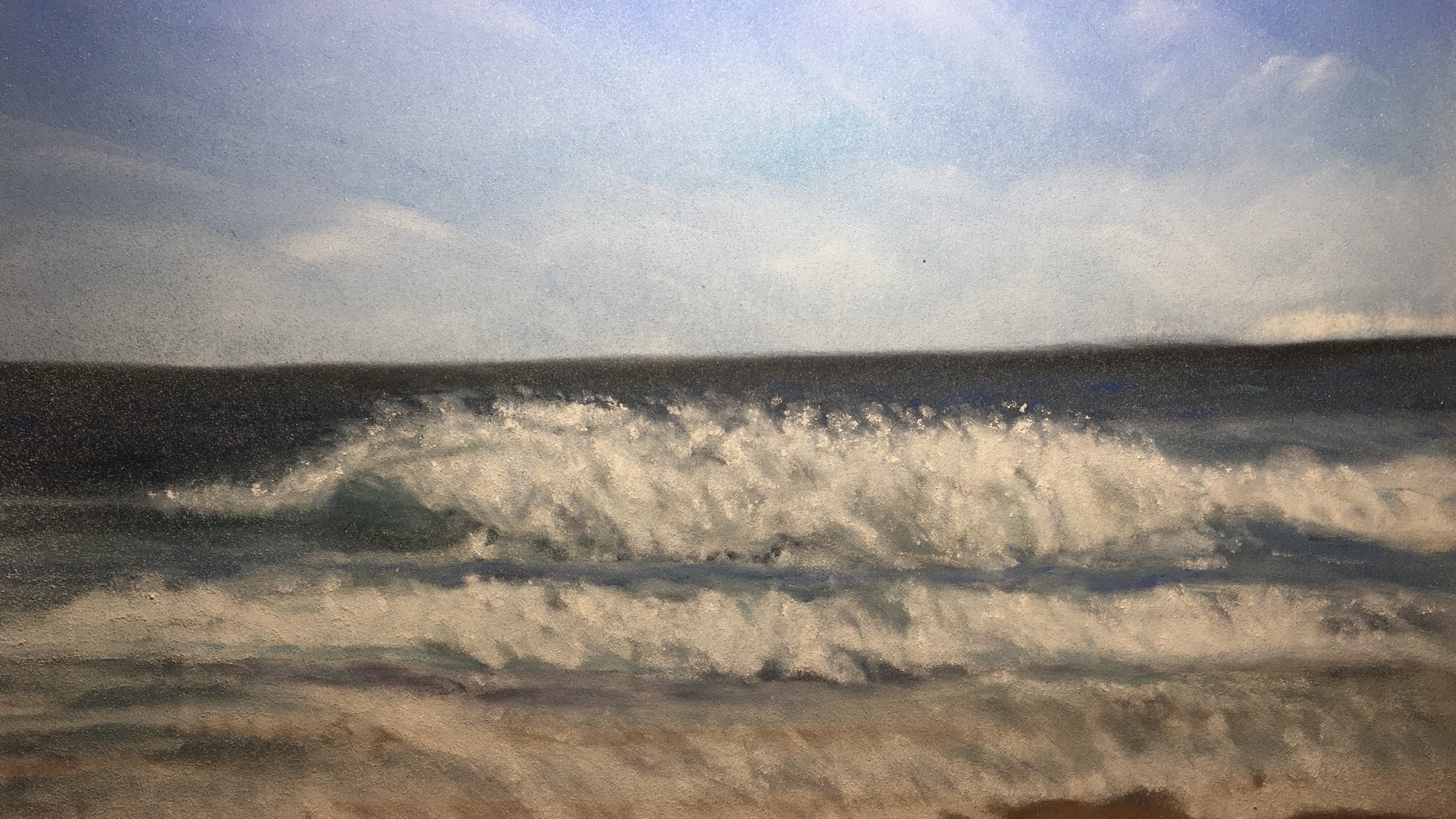 A photograph taken through a rain-covered window showing the ocean with waves and a cloudy sky.