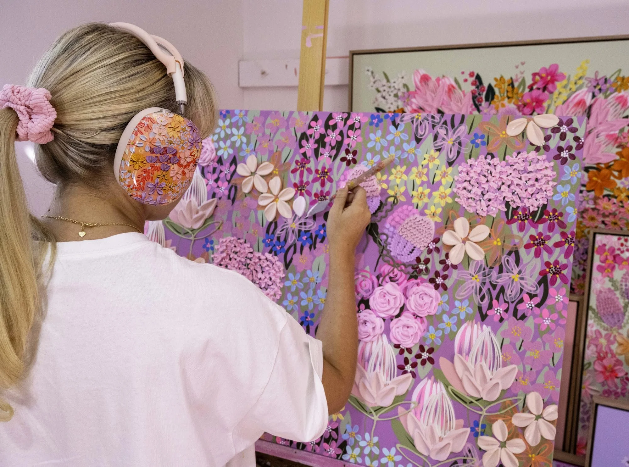 Artist Alex Mason at work painting in her studio.