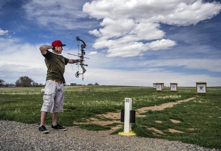 Man using a compound bow