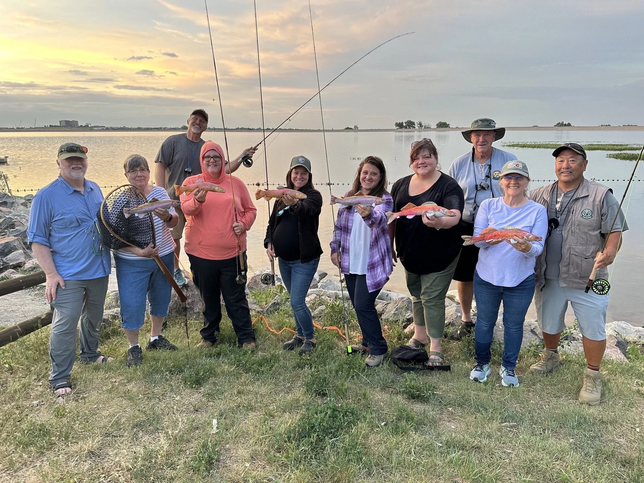 Group of people holding up fish