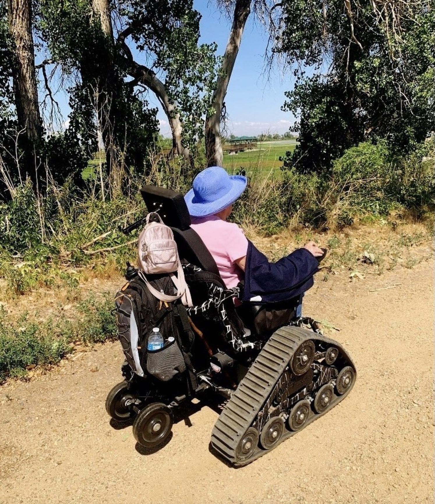 Woman using trackchair on trail
