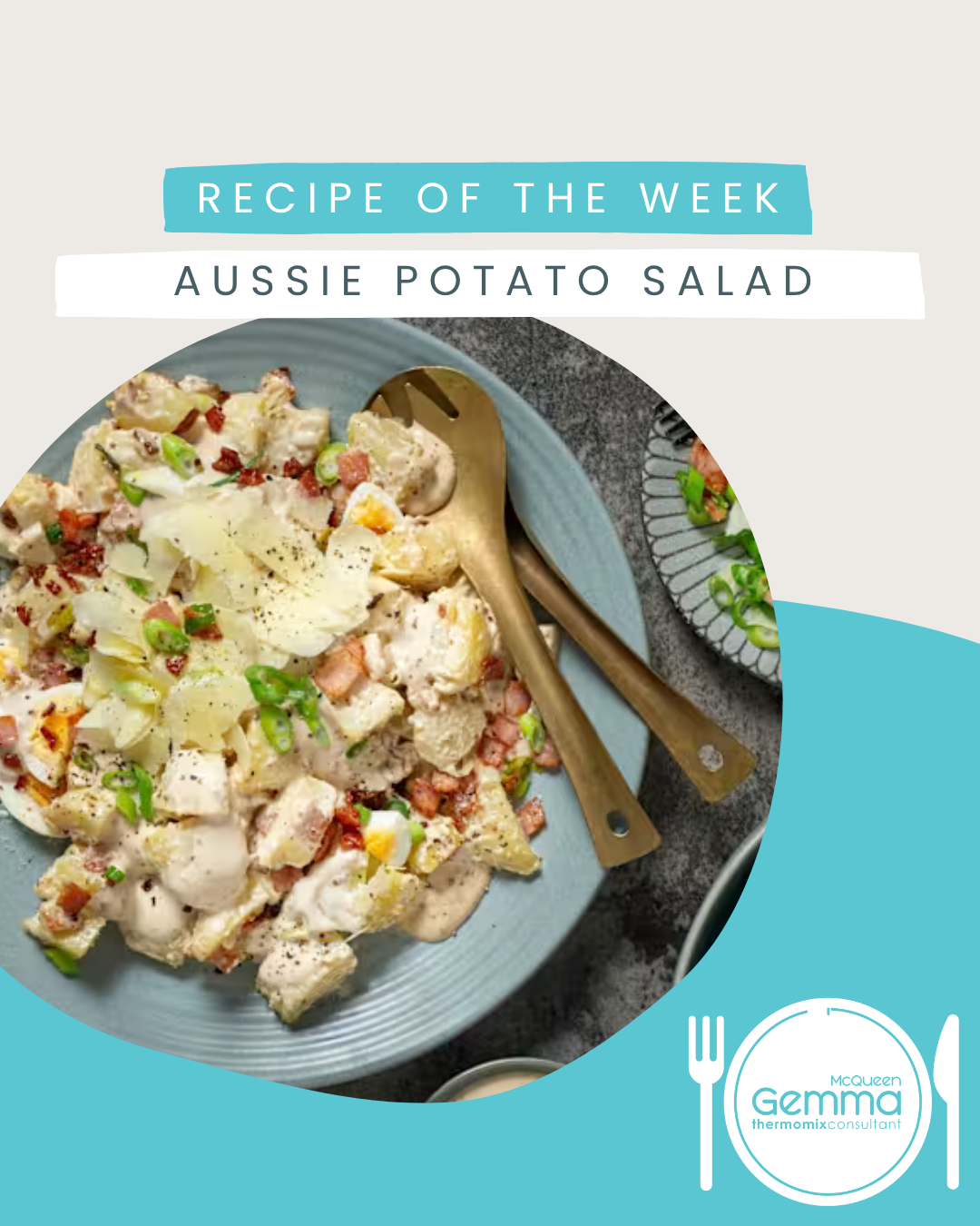 A plate of Aussie potato salad with chopped potatoes, bacon, green onions, and mayonnaise, served with utensils, on a dark surface.
