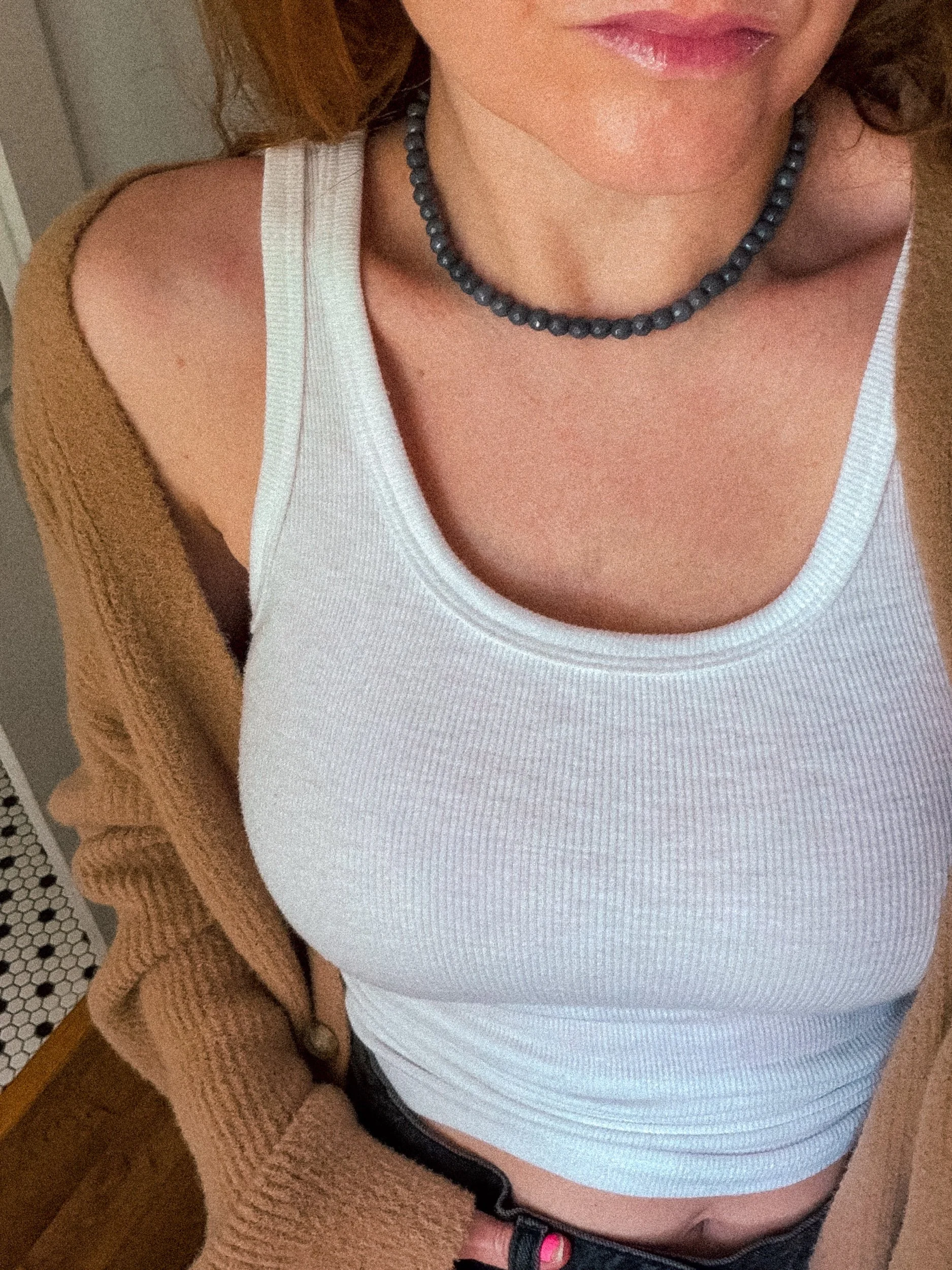 Handmade gray beaded necklace worn with a white ribbed tank top and brown cardigan