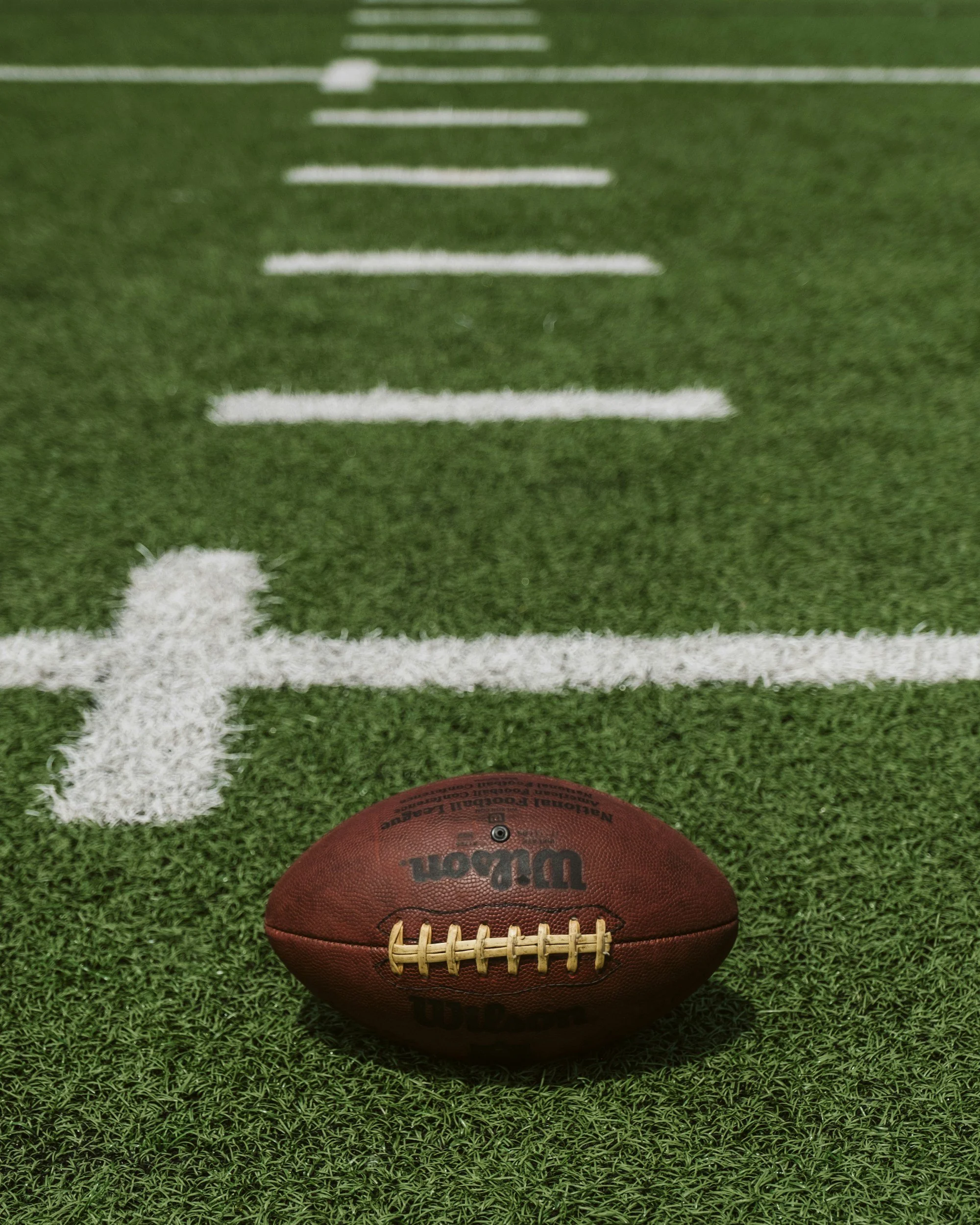 Football on turf of a football field.