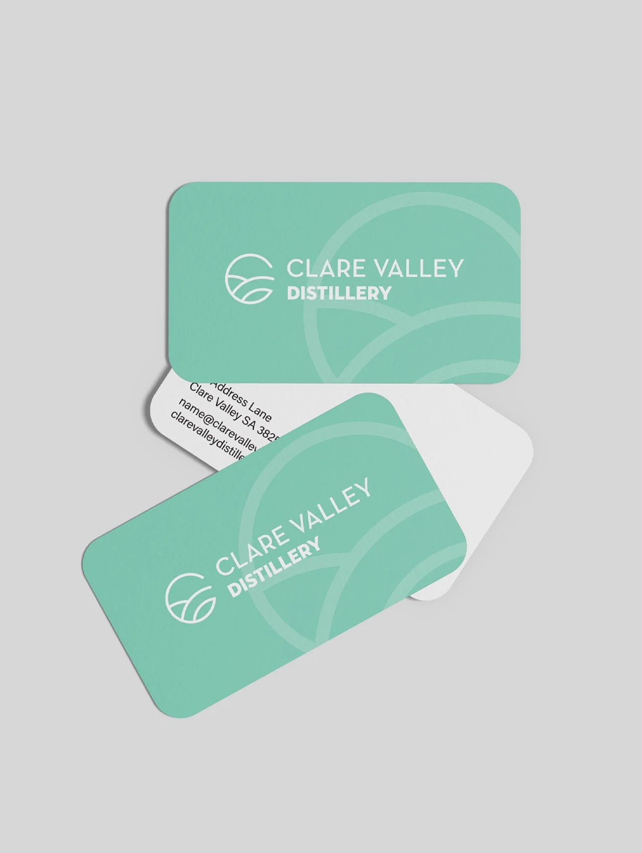 Business cards for Clare Valley Distillery in mint green with a logo and contact information.
